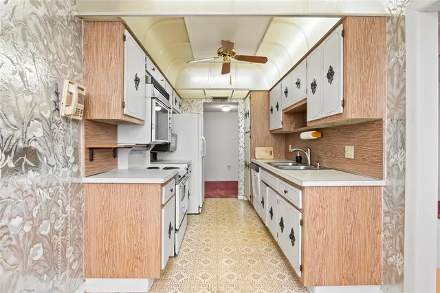 a view of a big room with wooden floor and windows