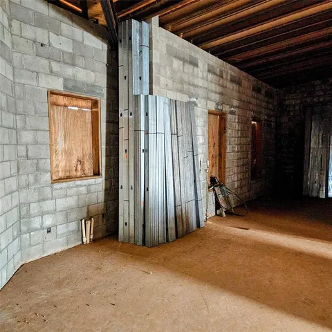 a view of a hall with wooden floor
