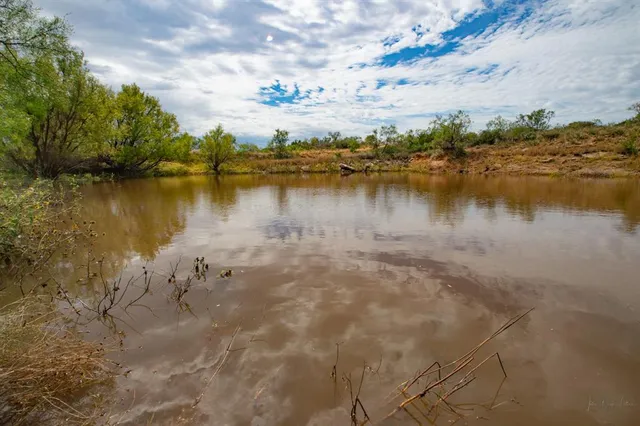 a view of a lake with houses in the background