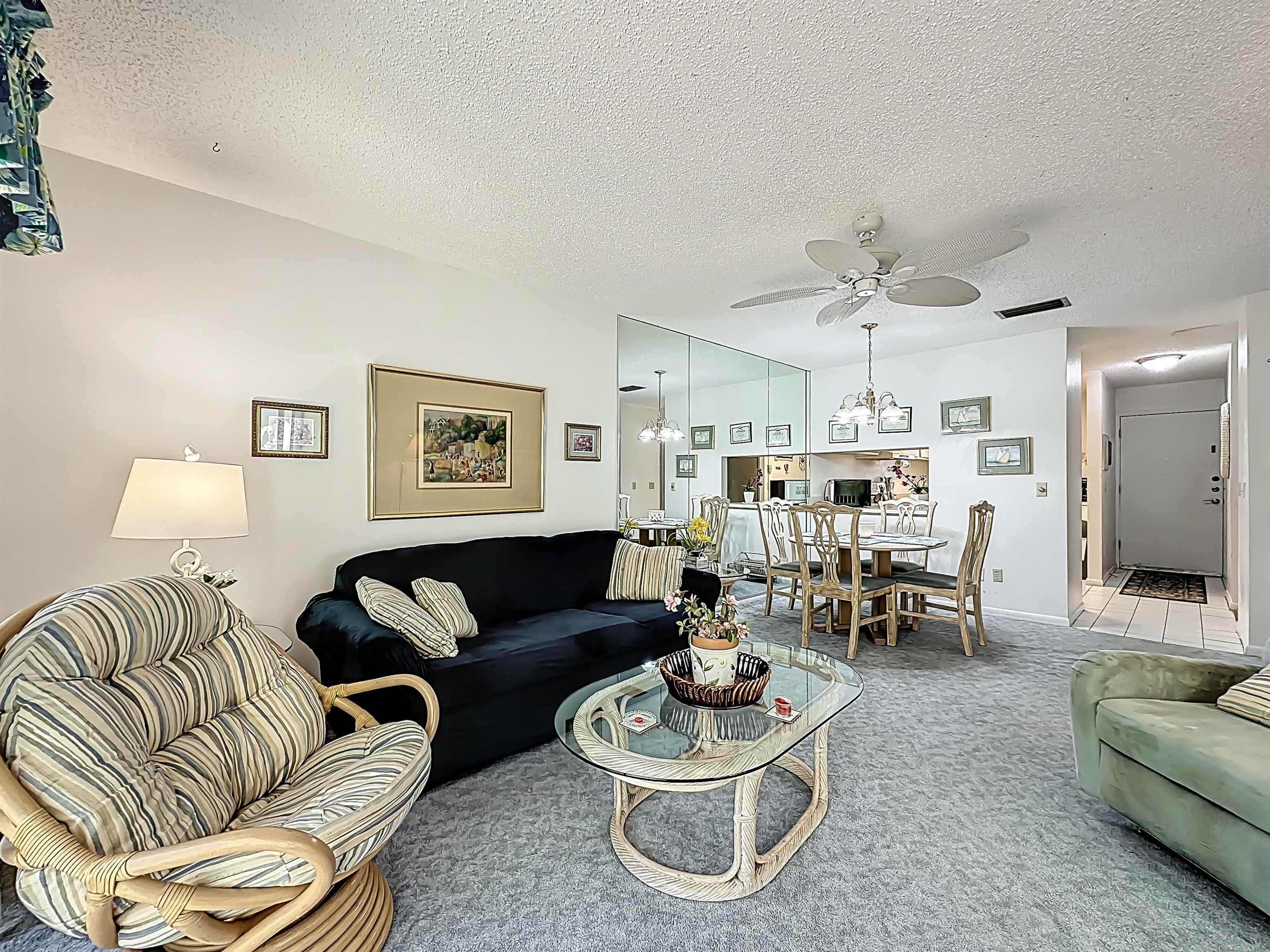 3960 A1A South, Unit 914 St. Augustine, FL 32080 - Photo 12 of 19 a living room with furniture and a large mirror with wooden floor
