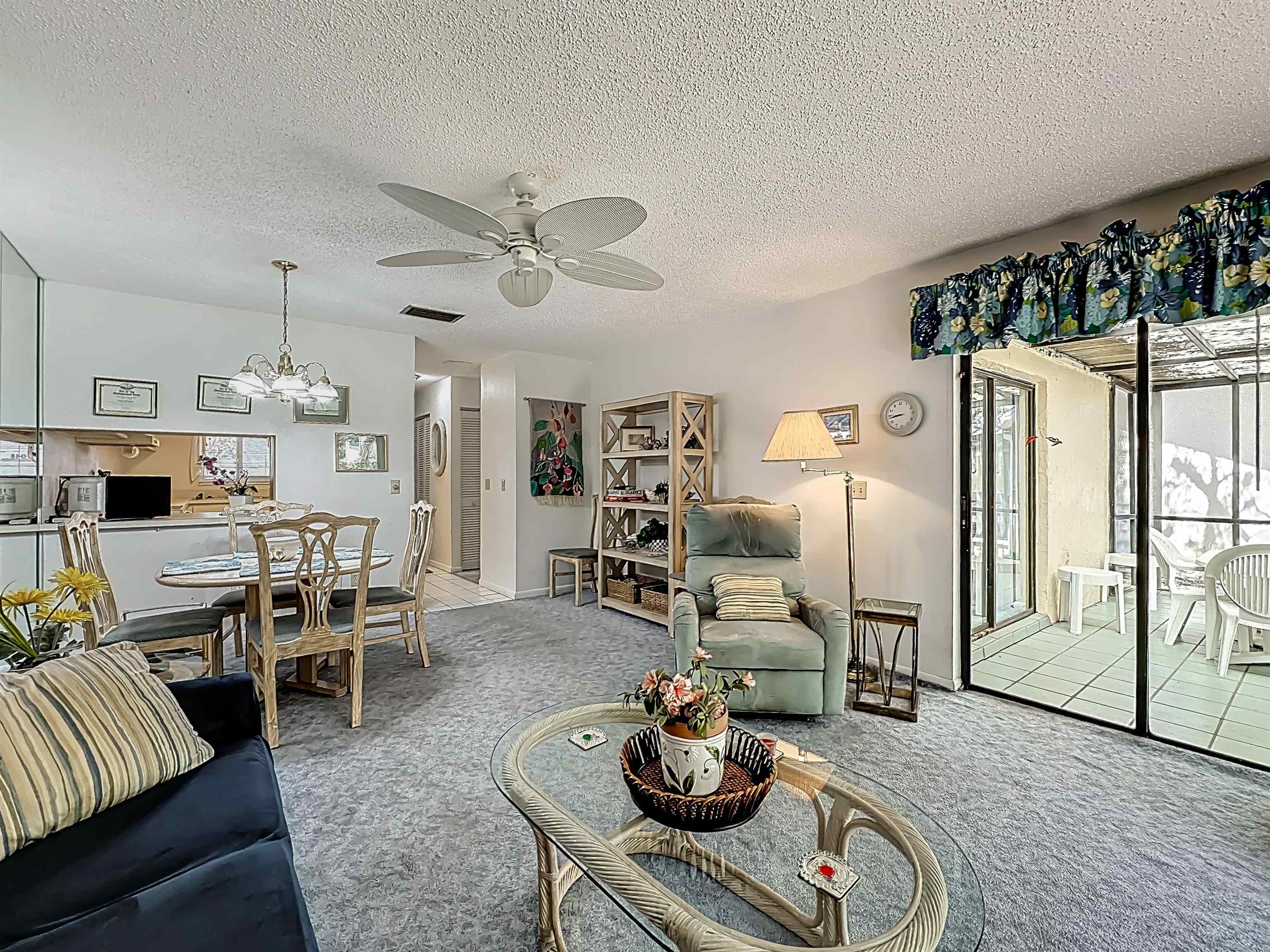 3960 A1A South, Unit 914 St. Augustine, FL 32080 - Photo 13 of 19 a living room with furniture kitchen view and a wooden floor