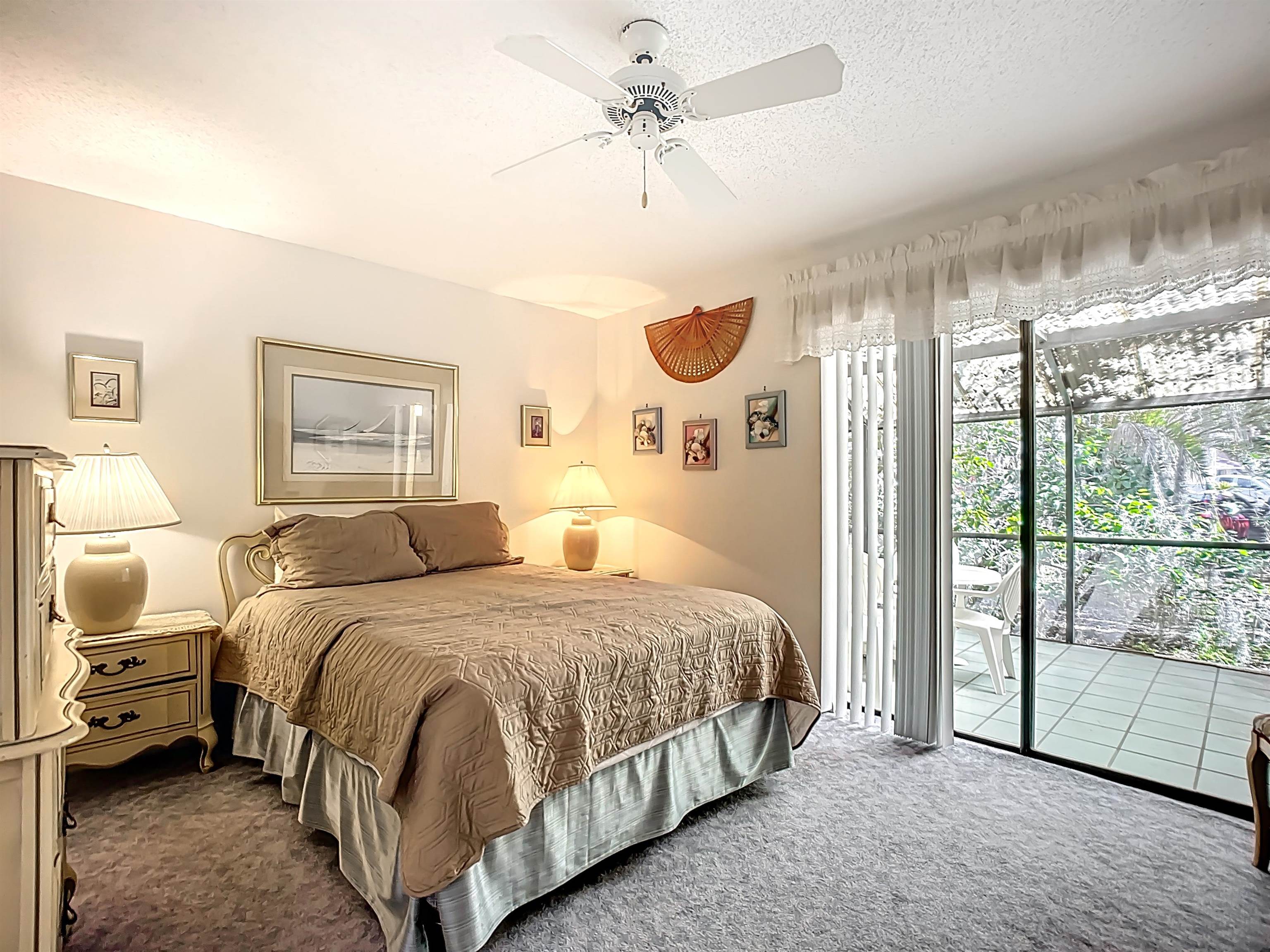 3960 A1A South, Unit 914 St. Augustine, FL 32080 - Photo 14 of 19 a bedroom with a bed mirror and a large window
