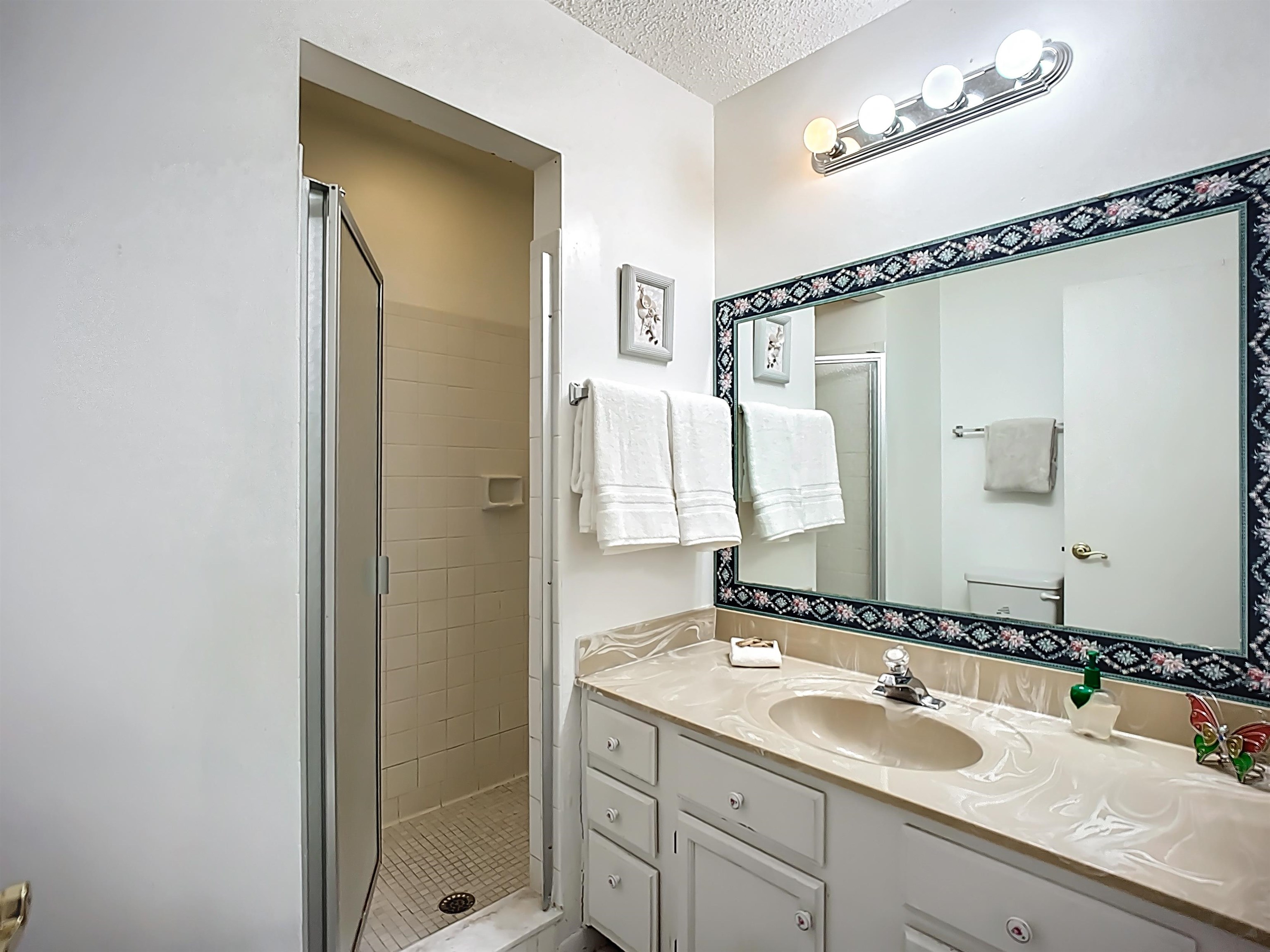 3960 A1A South, Unit 914 St. Augustine, FL 32080 - Photo 15 of 19 a bathroom with a double vanity sink and a mirror