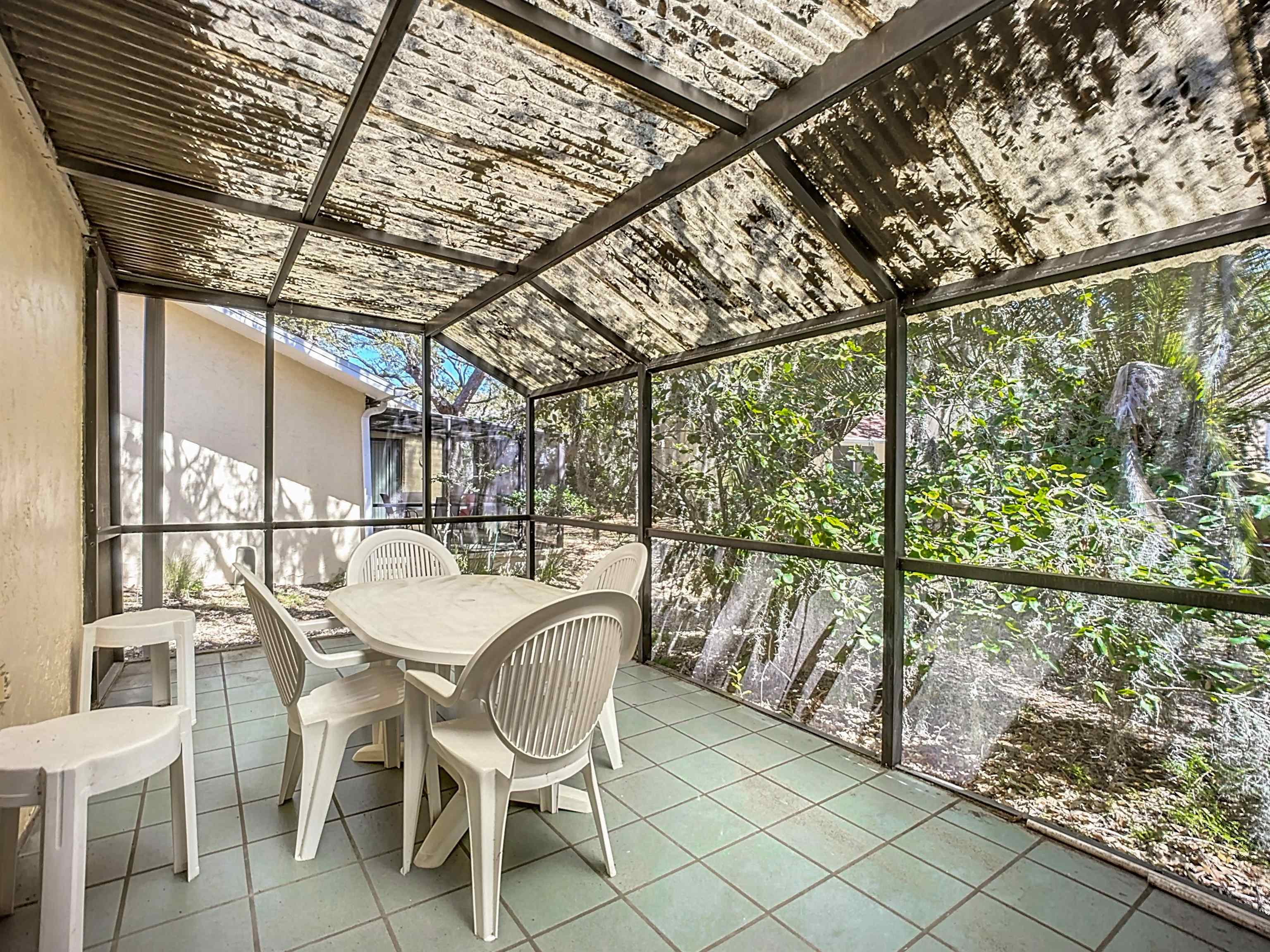 3960 A1A South, Unit 914 St. Augustine, FL 32080 - Photo 18 of 19 a dining room with furniture and a yard