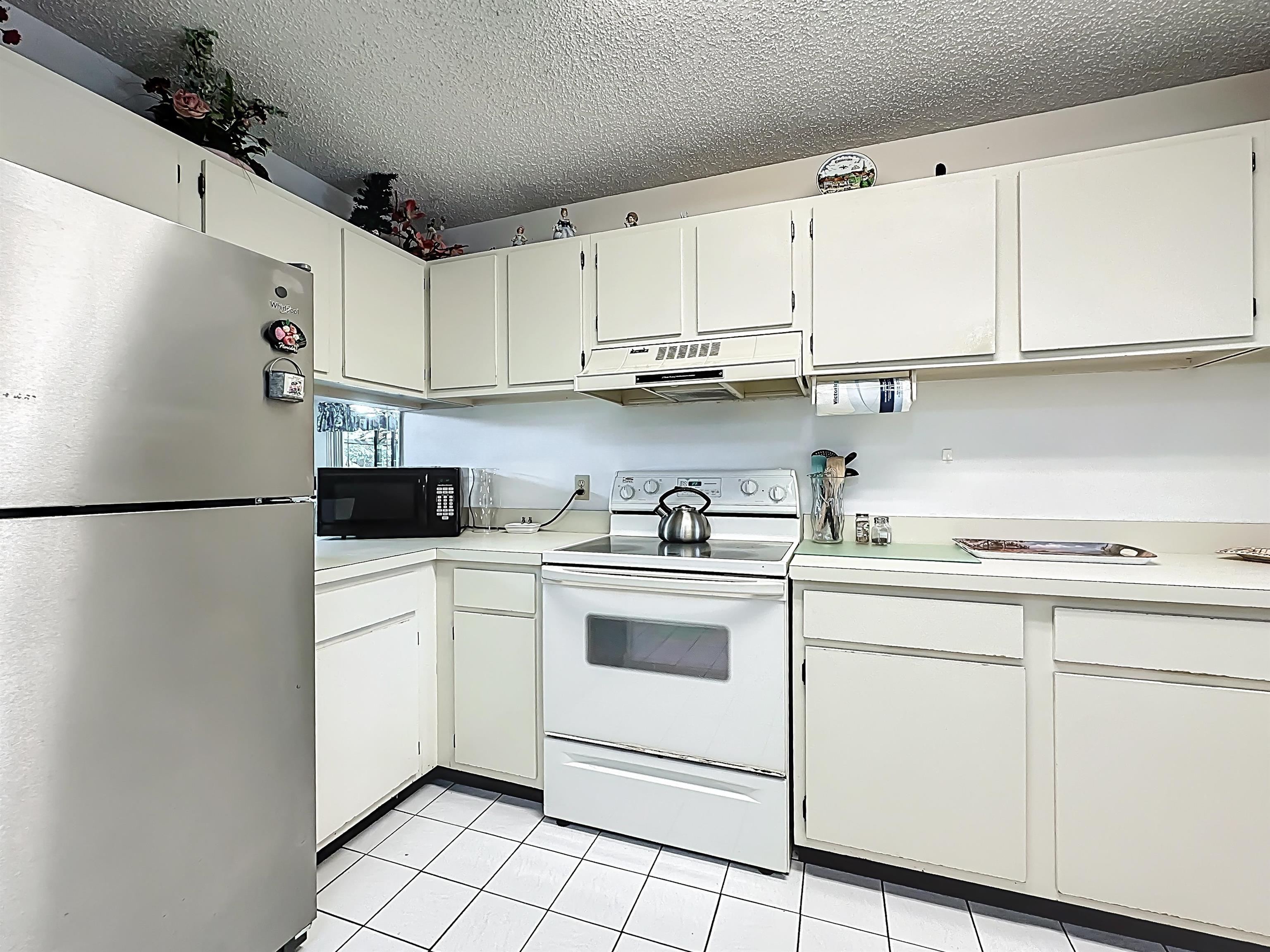 3960 A1A South, Unit 914 St. Augustine, FL 32080 - Photo 5 of 19 a kitchen with cabinets stainless steel appliances and sink