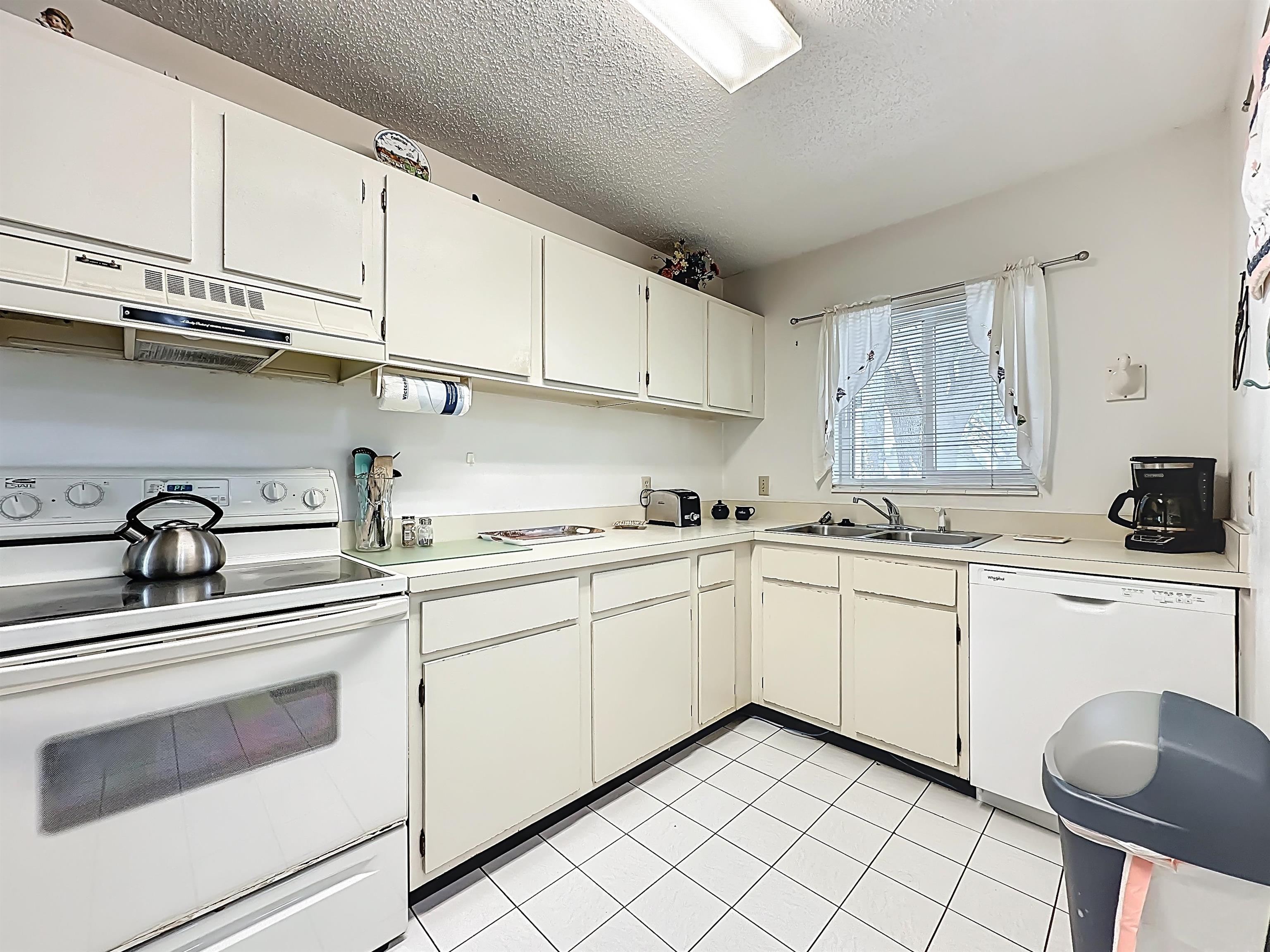 3960 A1A South, Unit 914 St. Augustine, FL 32080 - Photo 6 of 19 a kitchen with cabinets appliances a sink and a counter top space
