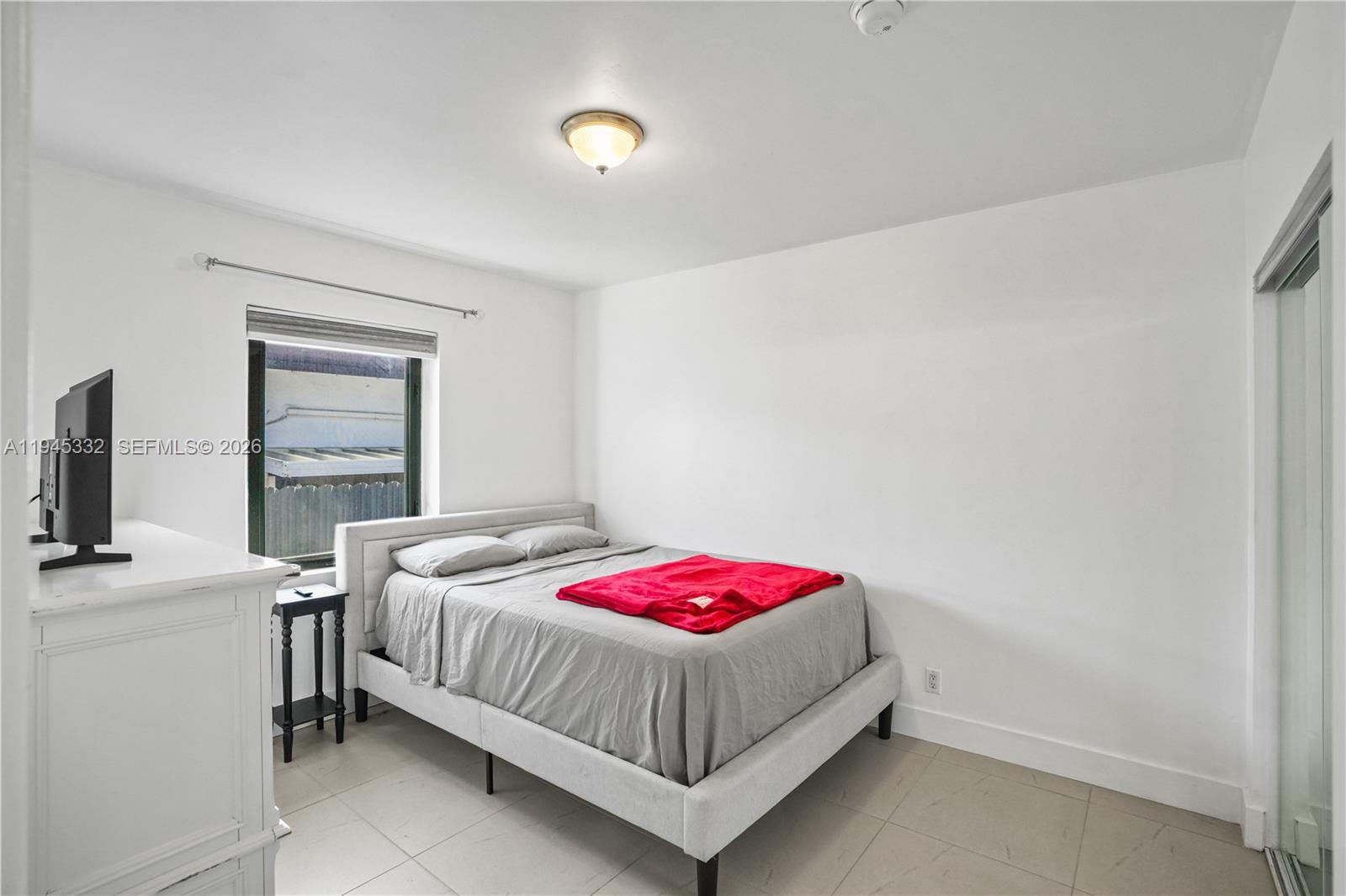 2290 Southwest 2nd Terrace Miami, FL 33135 - Photo 11 of 60 a bedroom with a bed and a window