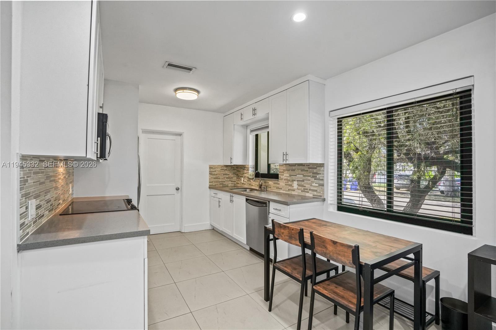 2290 Southwest 2nd Terrace Miami, FL 33135 - Photo 5 of 60 a kitchen with a stove a sink and a refrigerator