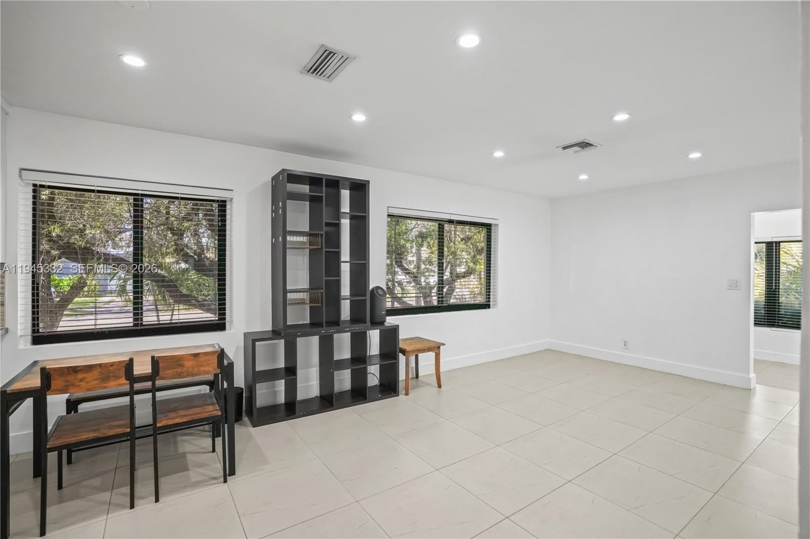 2290 Southwest 2nd Terrace Miami, FL 33135 - Photo 6 of 60 a view of an entryway with wooden floor and windows