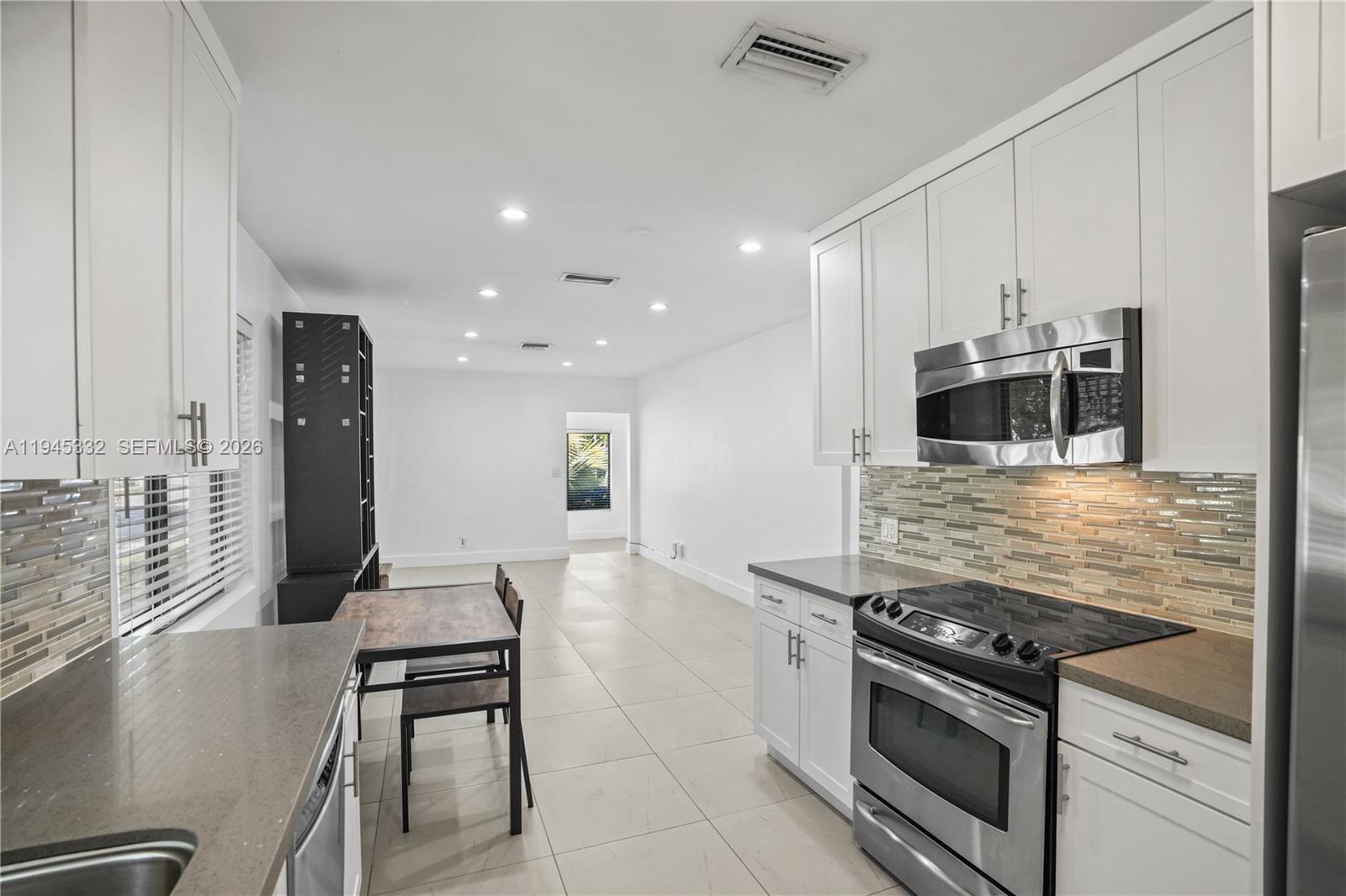 2290 Southwest 2nd Terrace Miami, FL 33135 - Photo 7 of 60 a large kitchen with stainless steel appliances granite countertop a stove and a refrigerator