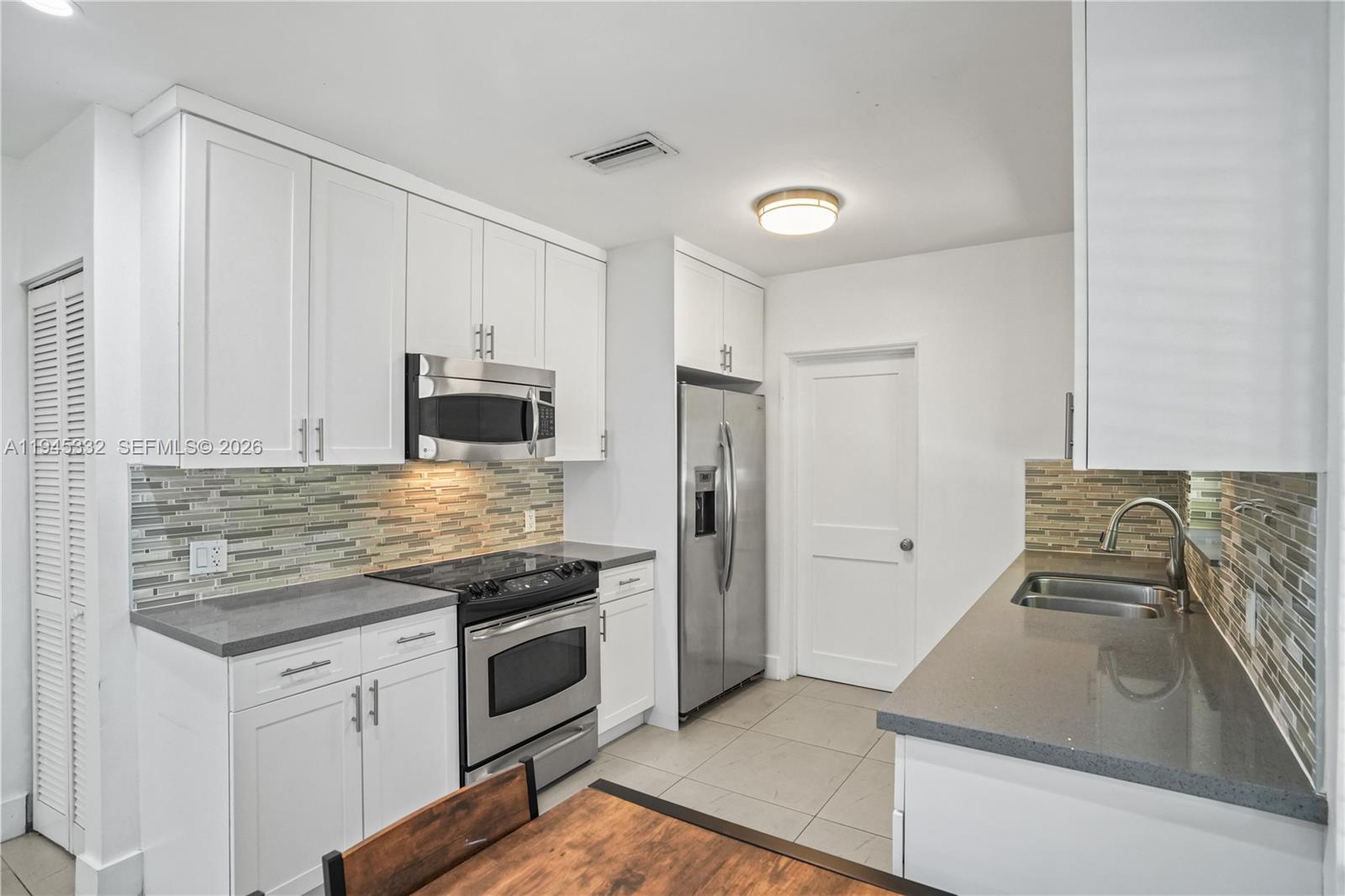 2290 Southwest 2nd Terrace Miami, FL 33135 - Photo 8 of 60 a kitchen with granite countertop a sink stove and refrigerator
