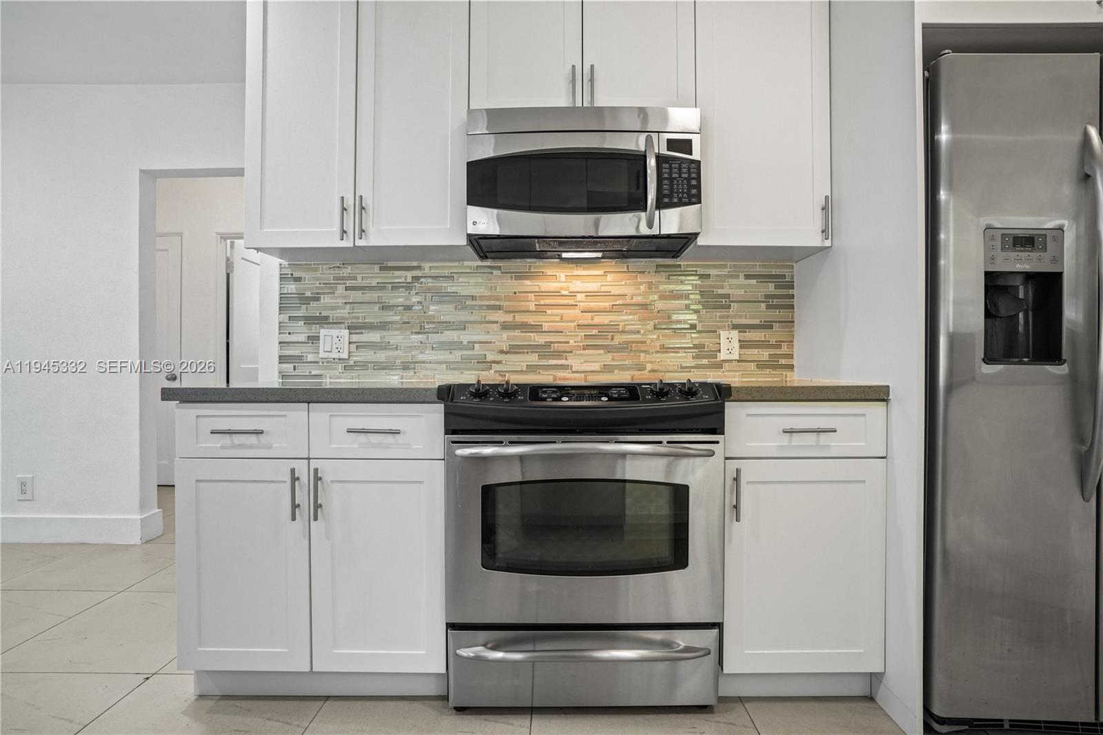 2290 Southwest 2nd Terrace Miami, FL 33135 - Photo 9 of 60 a kitchen with granite countertop white cabinets stainless steel appliances and a counter space