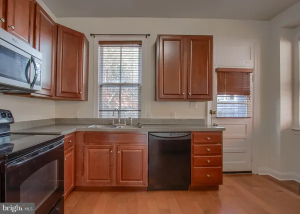 a kitchen with granite countertop a sink and cabinets