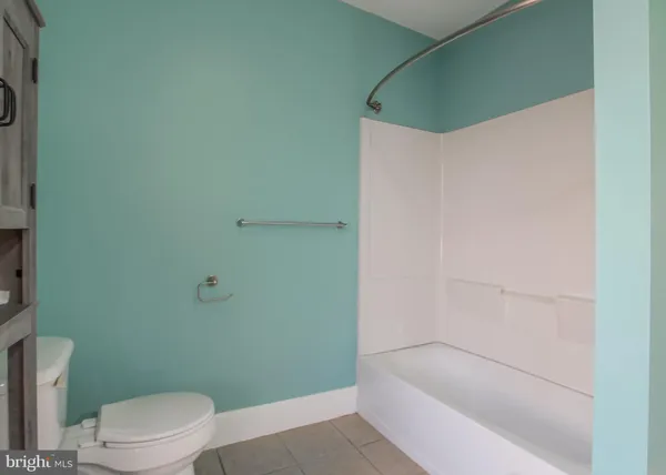 a bathroom with a bathtub and a toilet