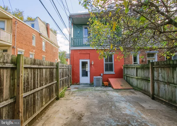 a view of a house with wooden fence