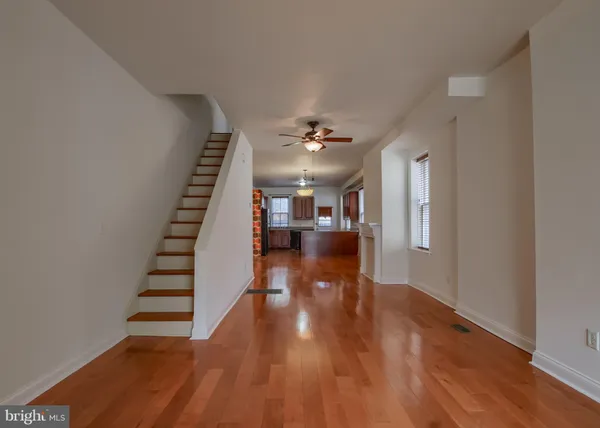 a view of entryway and hall with wooden floor