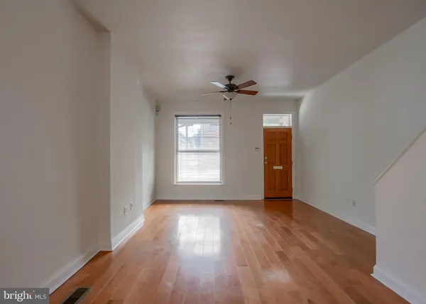 wooden floor in an empty room with a window