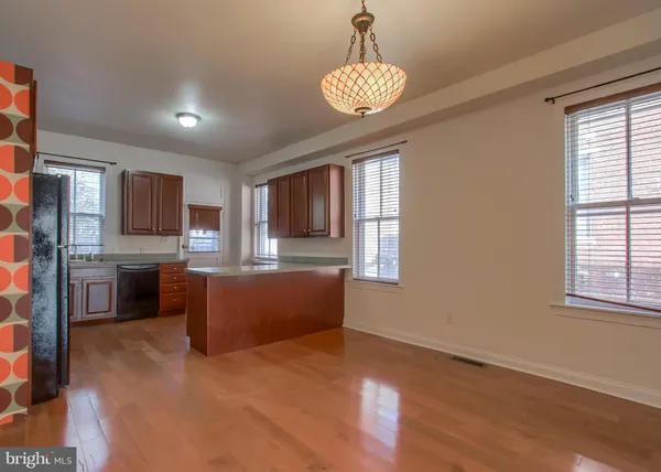 a living room with stainless steel appliances kitchen island granite countertop furniture and a kitchen view