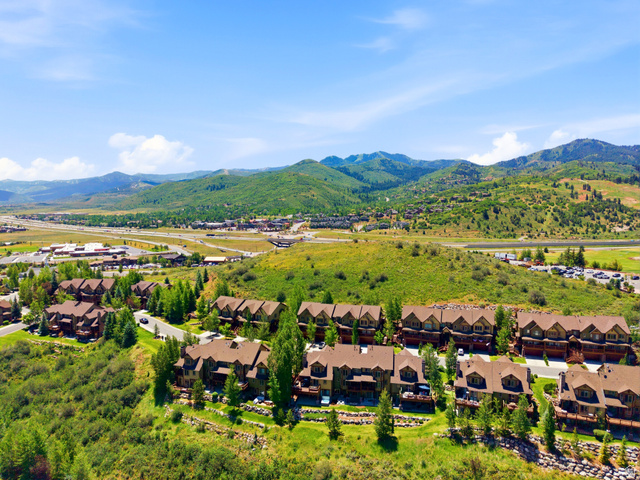 3148 Lower Saddleback Road Park City, UT 84098 - Photo 59 of 67 Expansive mountain landscape featuring multiple multi-story residences with brown roofs and exterior siding, surrounded by mature trees and lush green hillsides