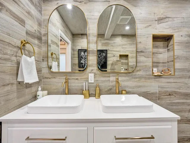 a bathroom with a sink a toilet and a mirror