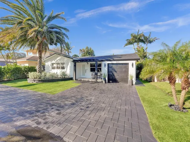 a view of a dining room with furniture a fireplace and wooden floor
