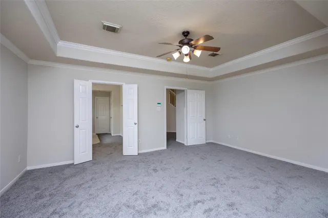 a view of an empty room with a ceiling fan