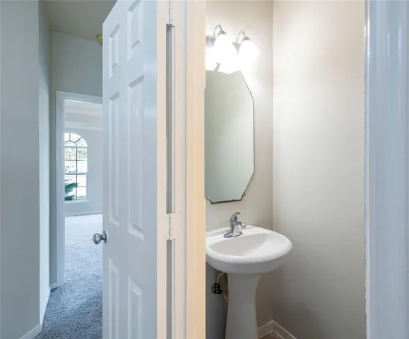 a bathroom with a sink a mirror and bathtub