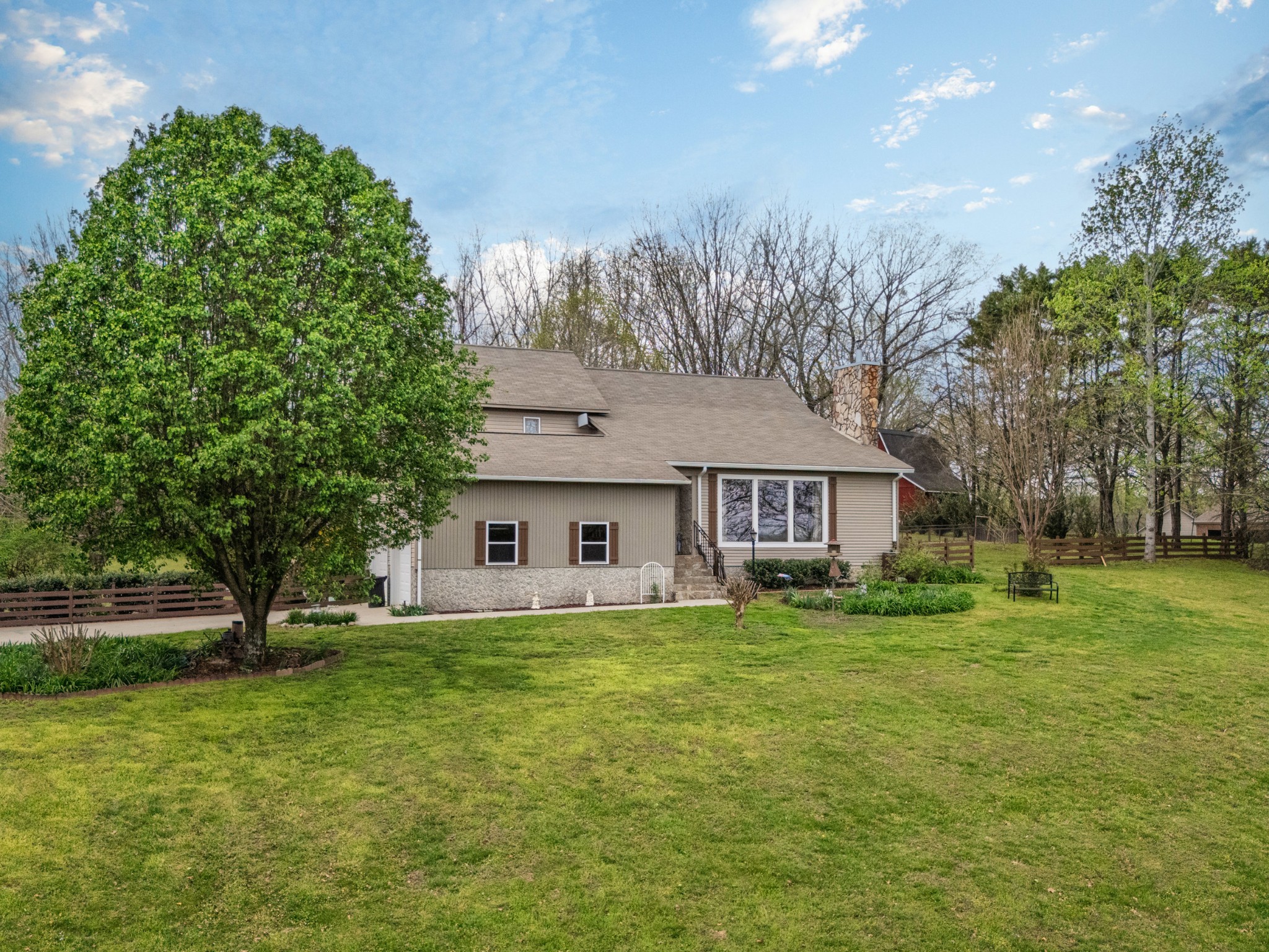 300 Wright Road Prospect, TN 38477 - Photo 4 of 65 a house that is sitting in the grass with large trees
