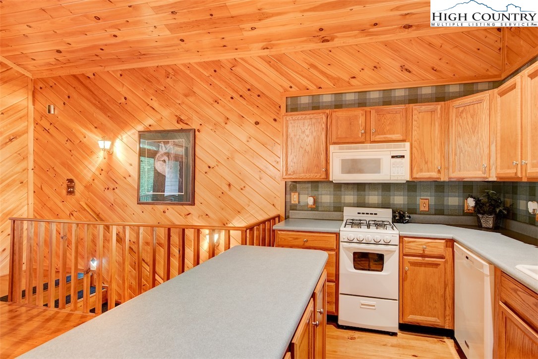 314 Sutherland Road Creston, NC 28615 - Photo 36 of 50 a kitchen with stainless steel appliances a stove a sink dishwasher and cabinets