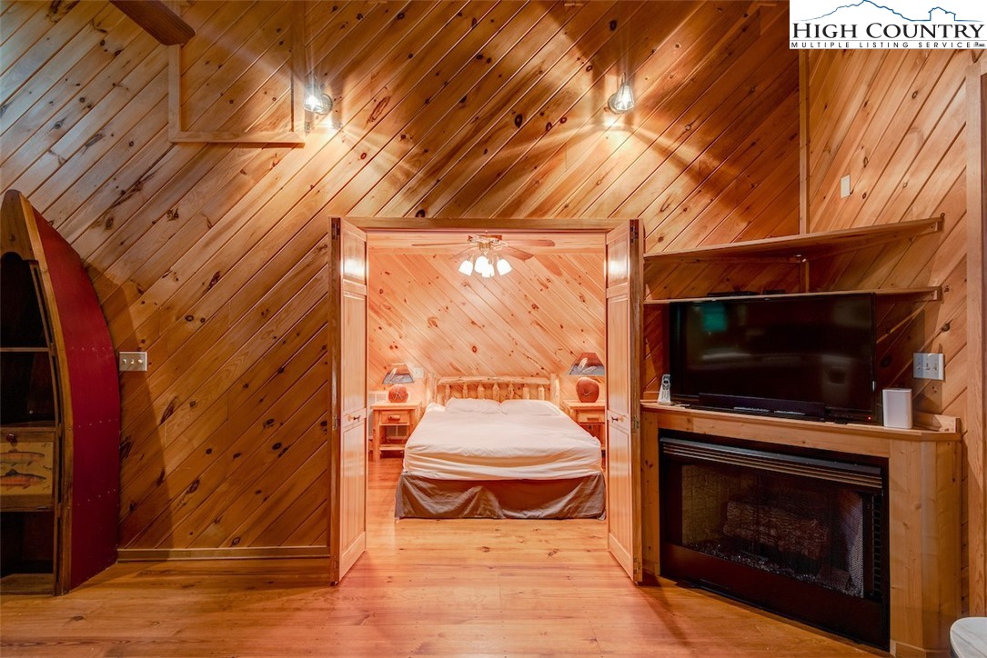 314 Sutherland Road Creston, NC 28615 - Photo 38 of 50 a living room with a fireplace and a flat screen tv