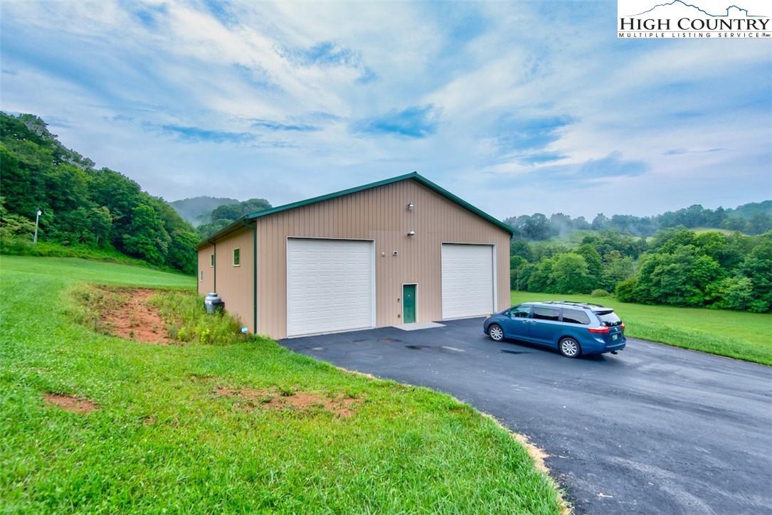 314 Sutherland Road Creston, NC 28615 - Photo 45 of 50 a house with green field in front of it