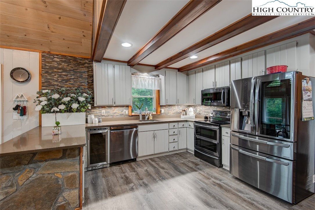 314 Sutherland Road Creston, NC 28615 - Photo 8 of 50 a kitchen with stainless steel appliances granite countertop a stove refrigerator sink and microwave