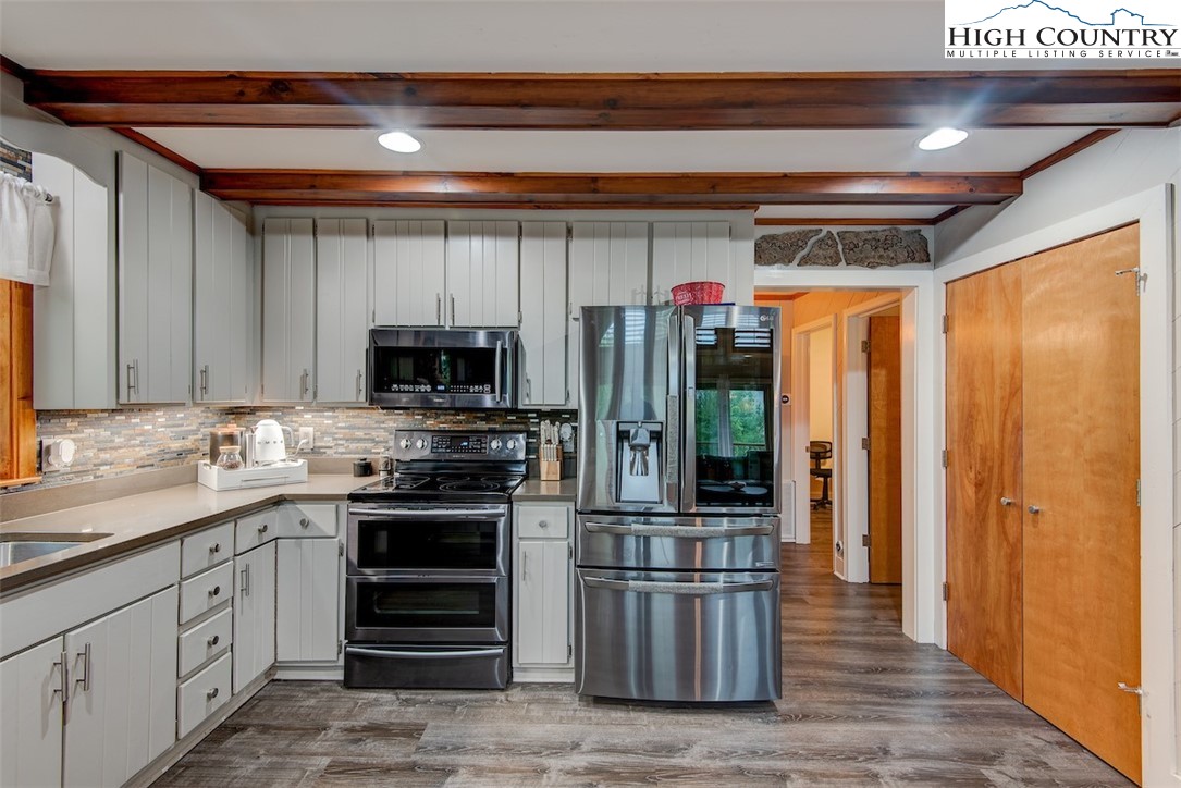 314 Sutherland Road Creston, NC 28615 - Photo 9 of 50 a kitchen with stainless steel appliances granite countertop a refrigerator and a sink