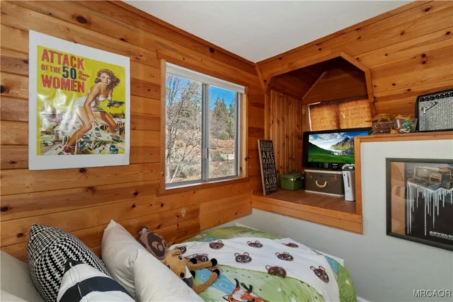 a bedroom with a bed and a painting on the wall