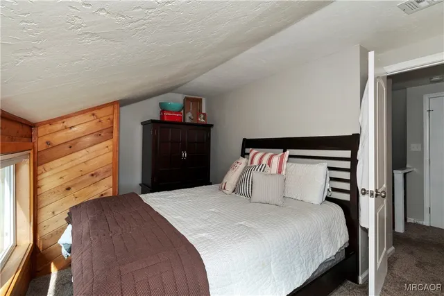 a bedroom with a bed and a closet