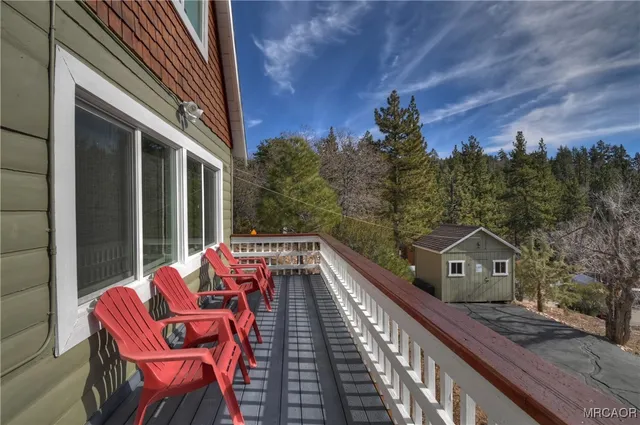 a balcony with table and chairs