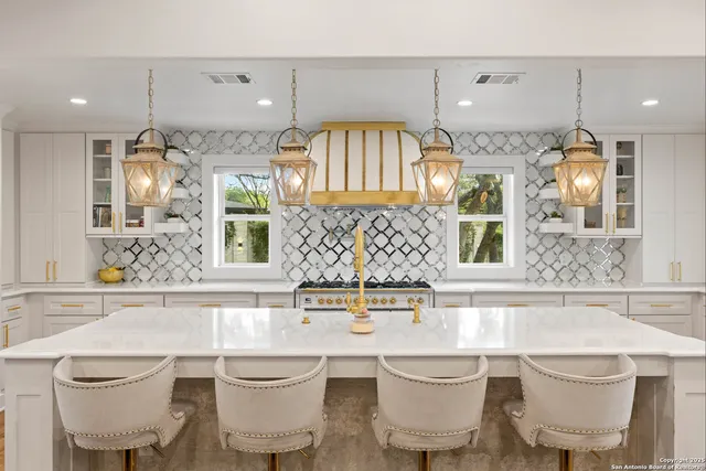 a large white kitchen with a large window