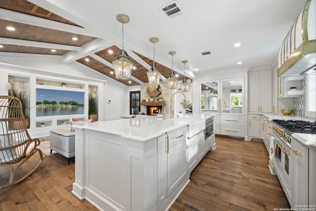 a kitchen with stainless steel appliances granite countertop a stove and a sink
