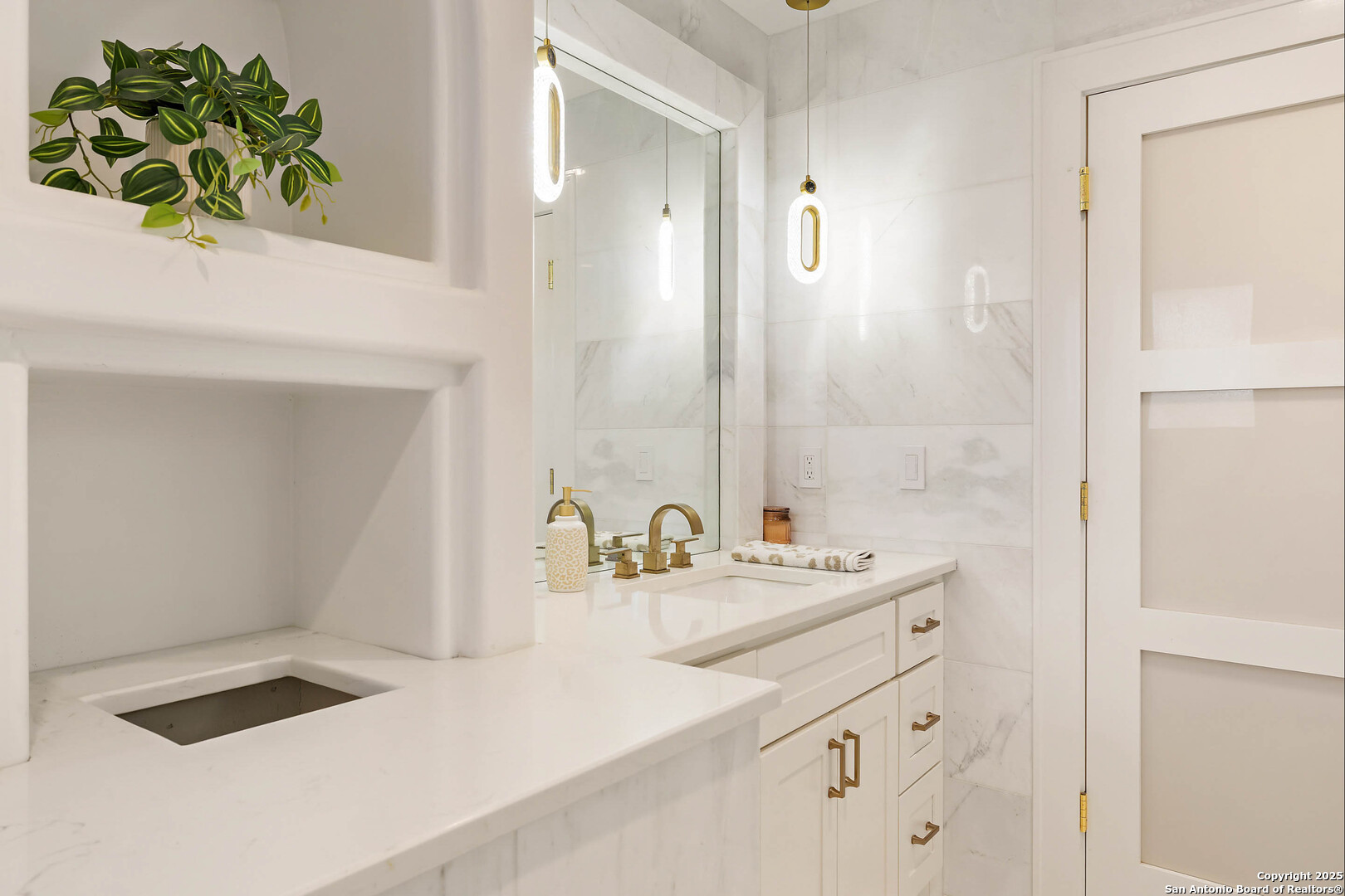 1310 Oak Springs Road Kingsland, TX 78639 - Photo 25 of 49 a bathroom with a sink a vanity and a mirror