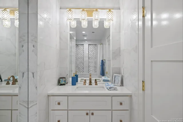 a bath tub sitting in a bathroom with a vase of flowers