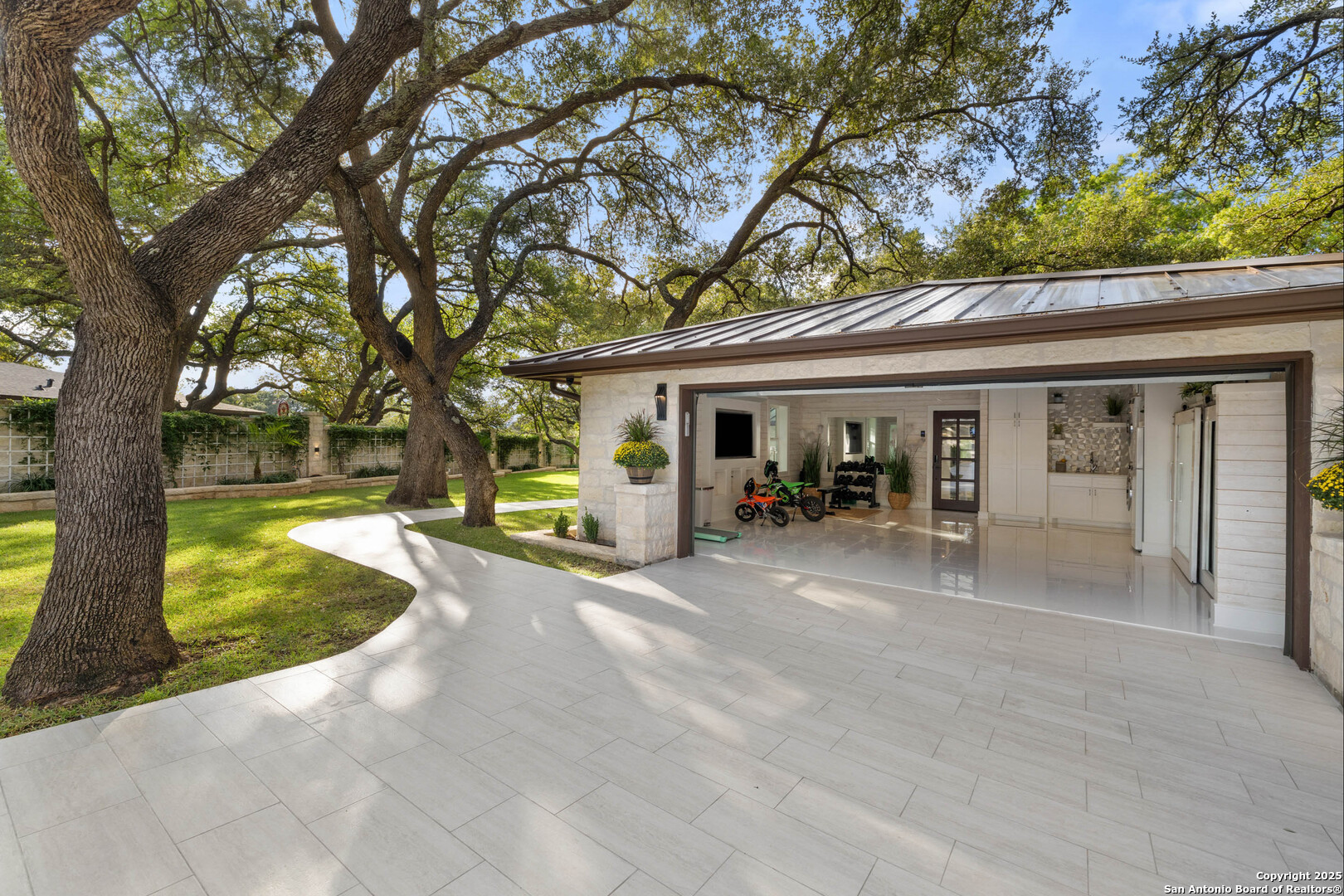 1310 Oak Springs Road Kingsland, TX 78639 - Photo 29 of 49 a view of a house with backyard porch and sitting area