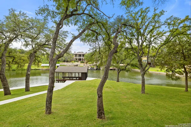 a view of a lake with lawn chairs