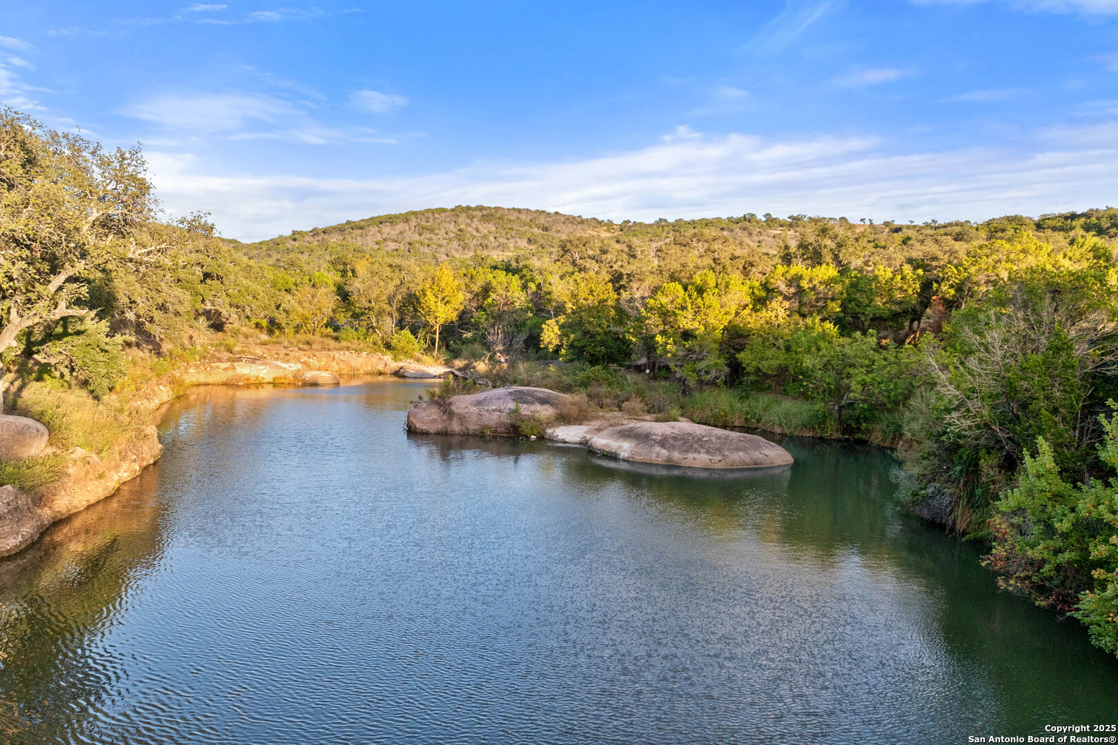 1310 Oak Springs Road Kingsland, TX 78639 - Photo 38 of 49 a view of a lake with lawn chairs