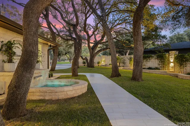 a roof deck with couches and potted plants