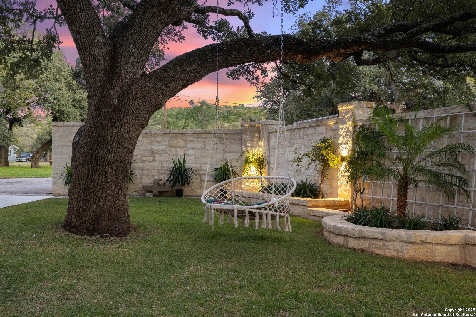 1310 Oak Springs Road Kingsland, TX 78639 - Photo 46 of 49 a view of backyard with table and chairs and a large tree