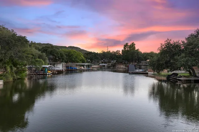 a view of river covered by trees and houses