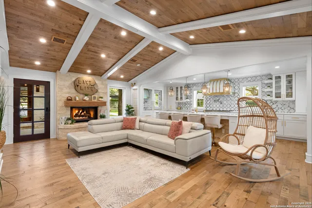 a living room with furniture a rug and a large window