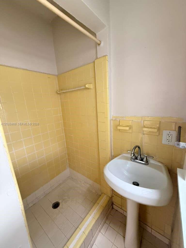 1919 Southwest 2nd Street, Unit B Miami, FL 33135 - Photo 12 of 12 a bathroom with a sink shower and a mirror
