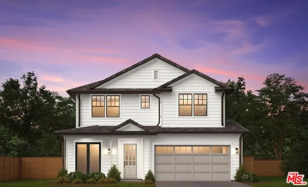 a house that has a clock on it with a small yard