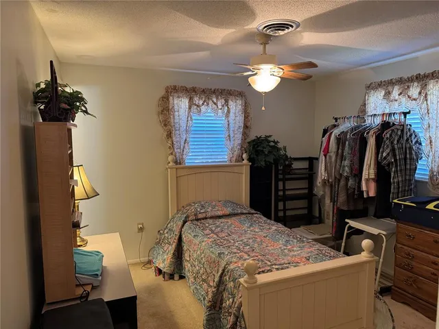 a bedroom with a bed and a mirror